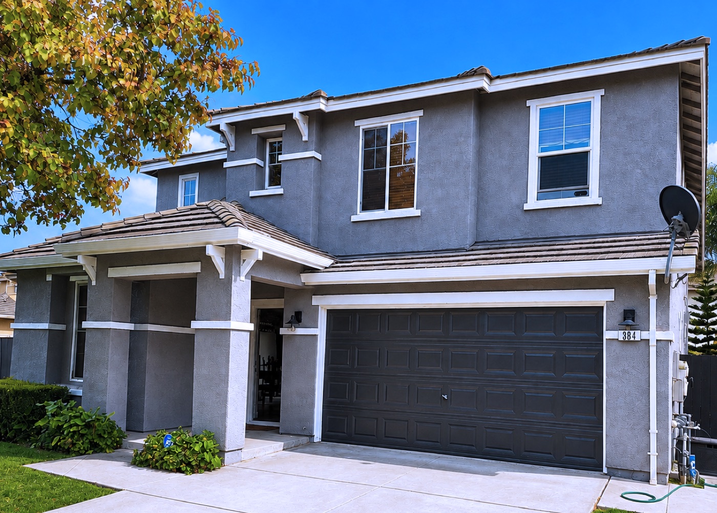 Same home after Master Craft Painting, fresh modern gray with crisp white trim